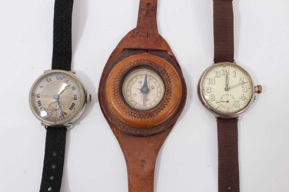 Lot 162 - First World War Officers Cyma trench wristwatch together with another similar and a compass on brown leather strap (3)
