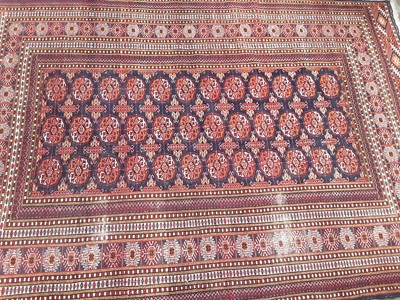 Lot 1139 - Eastern rug with geometric decoration on red and blue ground, 183cm x 127cm