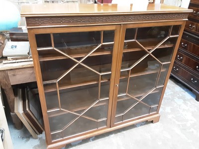 Lot 1143 - Good quality early 20th century mahogany bookcase with blind fret decoration and shelved interior enclosed by two astragal glazed doors, 121cm wide, 32cm deep, 122cm high