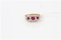 Lot 1616 - Gold (14ct) ruby and diamond ring with three...