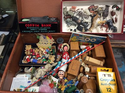 Lot 572 - Vintage suitcase containing wooden train set, miniature wooden figures, farm animals, tin plate wind up coffin bank and other items