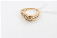 Lot 1631 - Gold (18ct) diamond set crossover ring with...