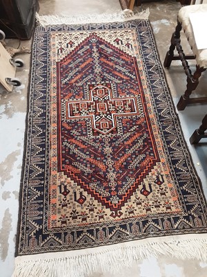 Lot 1197 - Eastern rug with geometric decoration on red, blue and orange ground, 190cm x 106cm