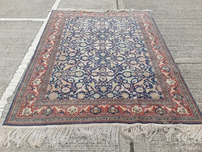 Lot 1198 - Eastern rug with geometric decoration on red, blue and cream ground, 251cm x 191.5cm