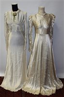 Lot 1477 - Two 1930s cream satin wedding dresses - one...