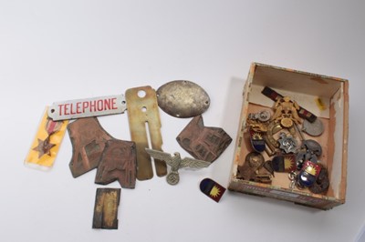 Lot 757 - Second World War medals comprising Africa Star x2 and War medal together with various other military badges including a Nazi badge and an enamel telephone box door plaque