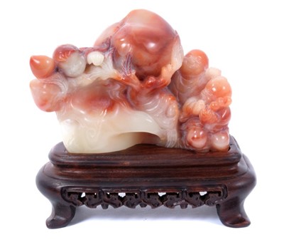 Lot 91 - Chinese carved hardstone group of deity figures and a peach, raised on wooden stand