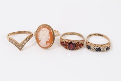 Lot 22 - Four 9ct gold rings to include 1970s sapphire and diamond five stone ring in carved scroll setting, similar style garnet ring, diamond set wishbone ring and cameo ring