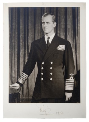 Lot 6 - H.R.H. The Duke of Edinburgh signed presentation portrait photograph of the Duke in Naval uniform signed in ink on mount 'Philip 1954' - unframed 24.5 x 17.6 cm