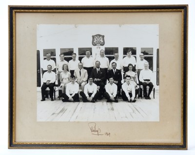 Lot 10 - H.R.H. The Duke of Edinburgh,signed photograph of The Duke with his staff on board H.M Yacht Britannia, signed in ink 'Philip 1964' in glazed frame 28cm x 35 cm overall Provenance: Given by The...
