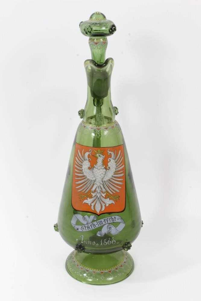 Lot 104 - Unusual Bohemian green glass decanter, enamelled with the Polish coat of arms, inscribed below and dated 1866, decorated with raspberry prunts and enamelled patterns, 38.5cm high