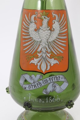 Lot 222 - Unusual Bohemian green glass decanter, enamelled with the Polish coat of arms, inscribed below and dated 1866, decorated with raspberry prunts and enamelled patterns, 38.5cm high