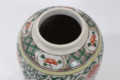 Lot 106 - Chinese famille verte ovoid porcelain vase and cover, 19th century, decorated with panels of flowers on a scrolling foliate-patterned ground, 21cm high