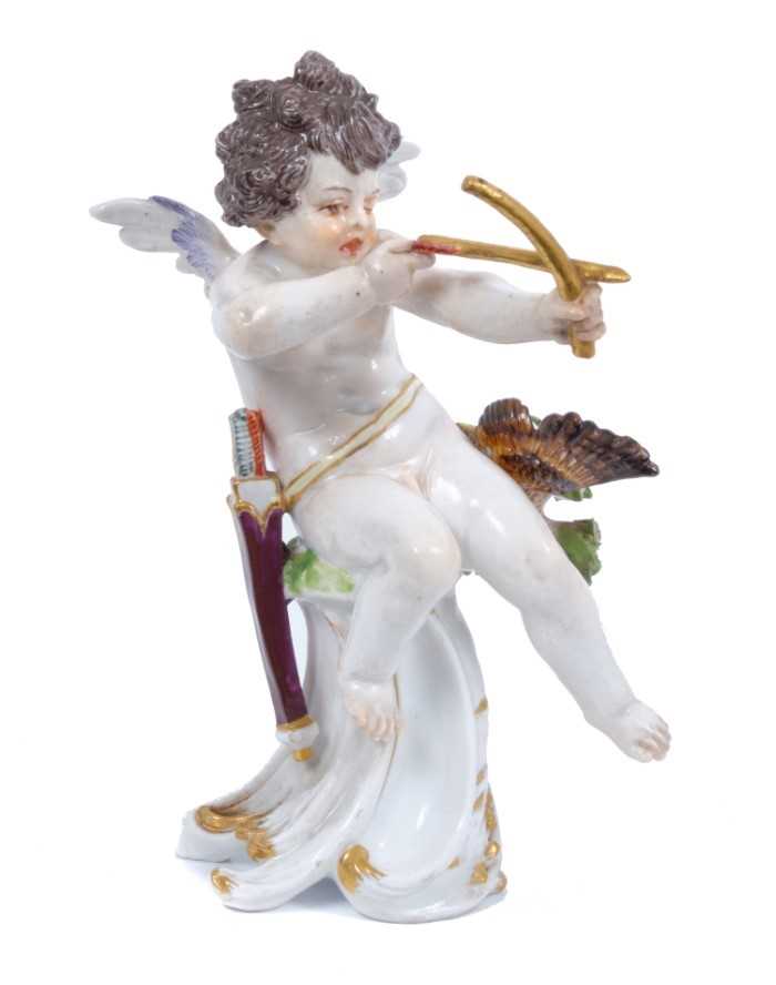 Lot 108 - Meissen figure of Cupid as an archer, circa 1900, shown seated on a scrollwork base, a shot bird on one side and sheaf of arrows on the other, crossed swords mark and impressed model number R 133 t...