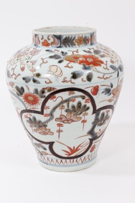 Lot 118 - Japanese Imari porcelain vase, 18th century, decorated with landscape panels, stylised flowers and foo dogs, 23cm high