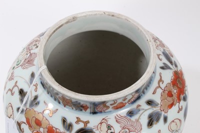 Lot 118 - Japanese Imari porcelain vase, 18th century, decorated with landscape panels, stylised flowers and foo dogs, 23cm high