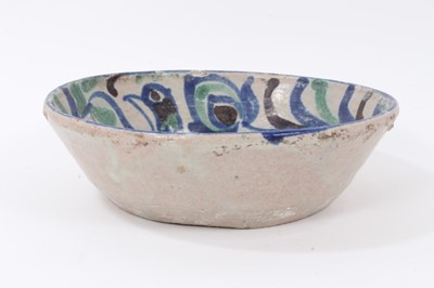 Lot 120 - Persian/Middle Eastern tin-glazed pottery bowl, painted with a bird and a foliate pattern in blue, green and black, 24.5cm diameter