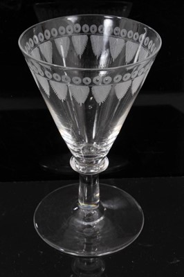 Lot 122 - Good set of twelve 19th century wine glasses, the bowls etched with a feather and circle pattern, on plain collared stems and conical feet, 12cm high