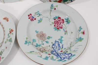 Lot 126 - Seven Chinese famille rose dishes, Qianlong period, decorated with flowers, birds and fenced gardens, including two pairs, each approx 23cm diameter