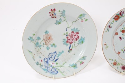 Lot 126 - Seven Chinese famille rose dishes, Qianlong period, decorated with flowers, birds and fenced gardens, including two pairs, each approx 23cm diameter