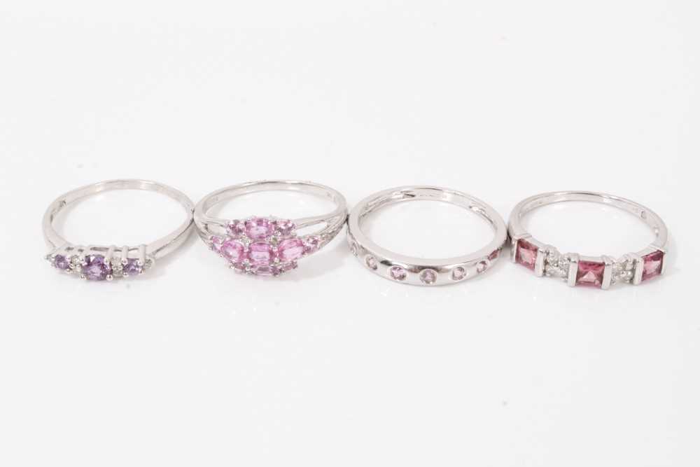 Lot 77 - Four 9ct white gold pink stone dress rings