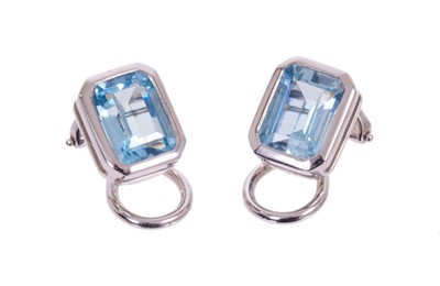 Lot 522 - Pair of aquamarine and 18ct white gold earrings with an octagonal step cut aquamarine measuring approximately 8.2 x 6.5mm in 18ct white gold rub-over setting with clip fittings, Hallmarked London 2...