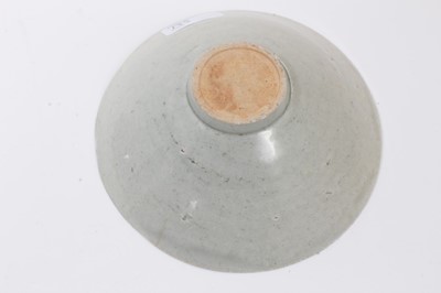 Lot 135 - Two early Chinese bowls, probably Song Dynasty, one with a Qingbai glaze and incised with a cloud pattern, 19cm diameter, the other with a greyish-green celadon glaze, incised with a similar patter...