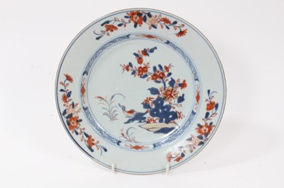 Lot 136 - Four pieces of 18th century Chinese export porcelain, including an Imari bowl, two Imari dishes, and a famille rose dish, each decorated with flowers, the bowl measuring 24cm diameter
