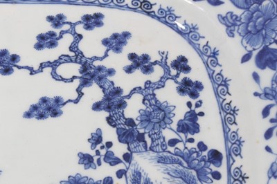 Lot 137 - Chinese blue and white porcelain platter, 18th century, decorated with a figure standing on an island by a rocky outcrop, 35cm across