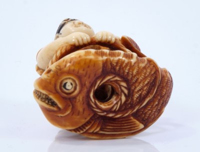 Lot 799 - A Japanese ivory netsuke, in the form of Edisu, the god of fishing, standing on a giant sea bream