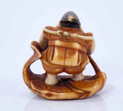 Lot 799 - A Japanese ivory netsuke, in the form of Edisu, the god of fishing, standing on a giant sea bream