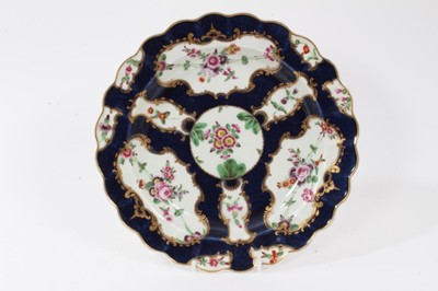 Lot 201 - A Worcester plate, painted with flowers, on a blue scale ground, circa 1770