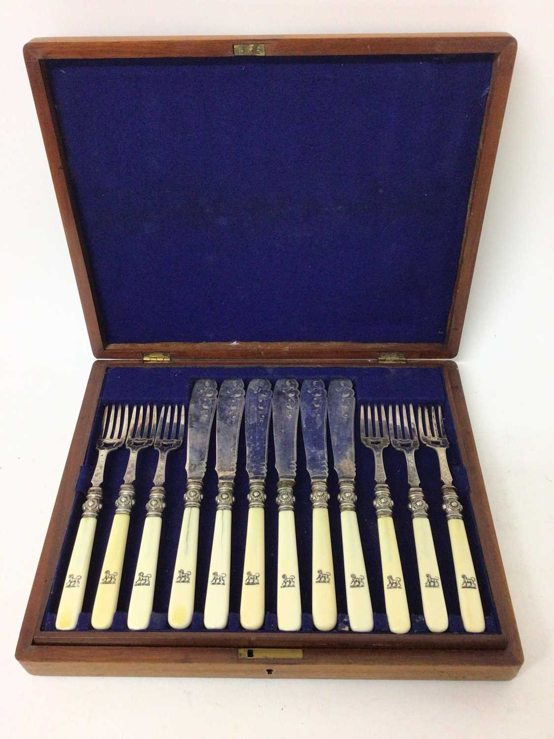 Lot 231 - Victorian canteen of twelve pairs of silver plated fish eaters with engraved decoration and turned ivory handles with engraved armorials in blue baize lined mahogany canteen
