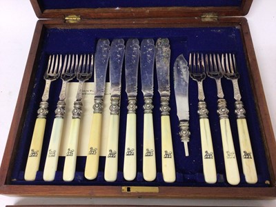 Lot 231 - Victorian canteen of twelve pairs of silver plated fish eaters with engraved decoration and turned ivory handles with engraved armorials in blue baize lined mahogany canteen