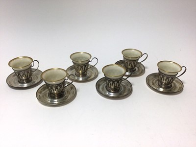 Lot 463 - Set of six American sterling silver coffee cups and saucers with porcelain cup liners