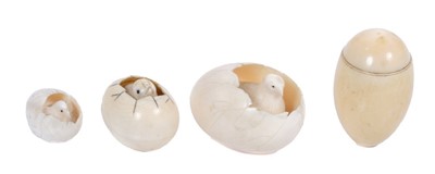 Lot 829 - Unusual carved ivory figure of a chick in an egg, two similar and a similar ornament