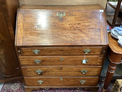 Lot 1028 - Early 19th century elm bureau on bracket feet