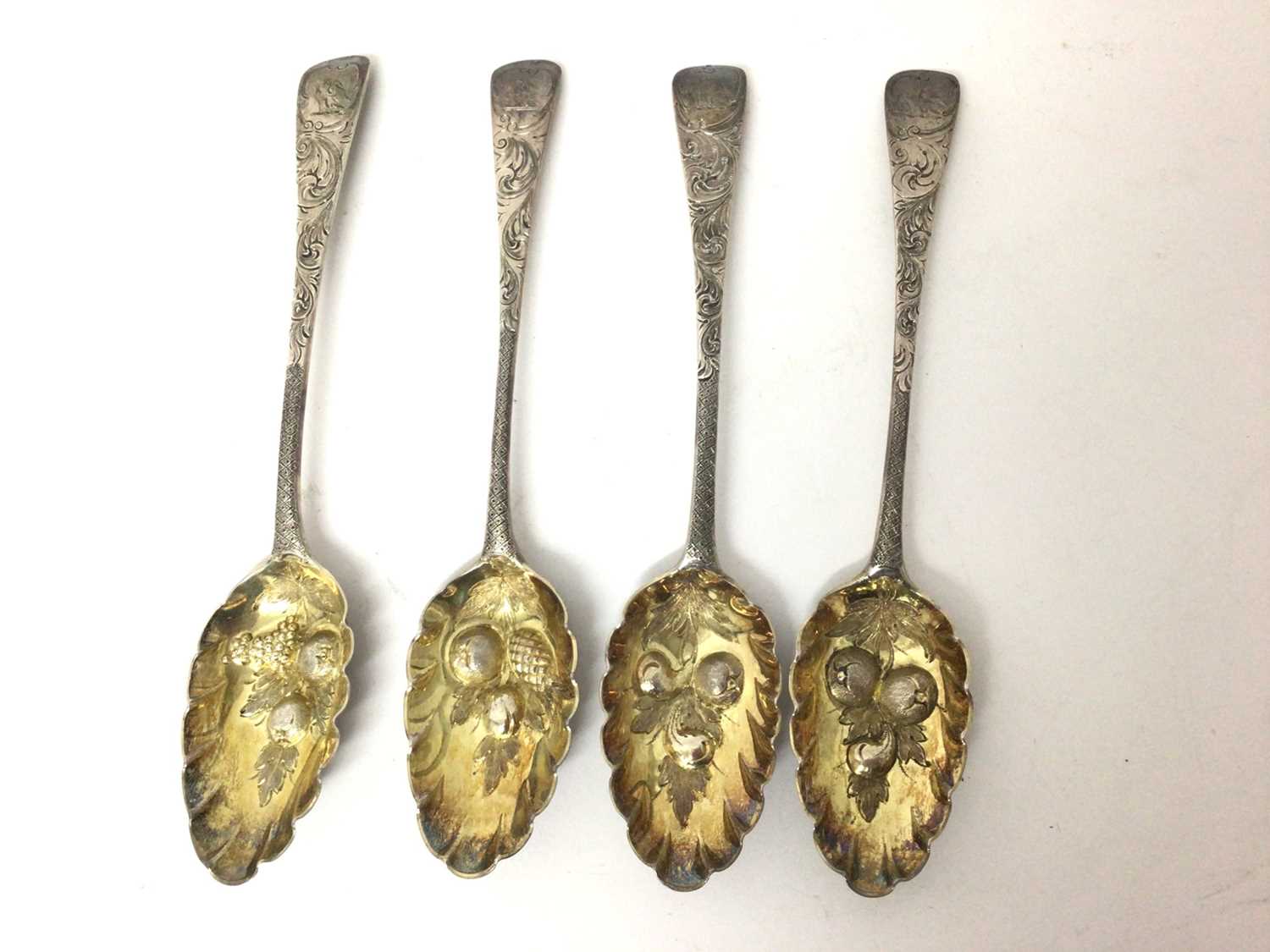 Lot 451 - Four Georgian silver berry spoons