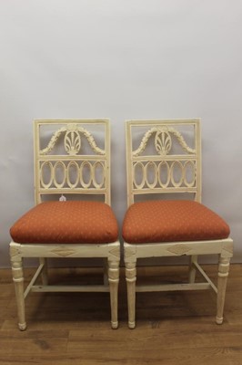 Lot 1313 - Pair of 19th century Continental, possibly Swedish, white painted salon chairs, each in the Biedermeier style, with pierced and cushion seat on fluted legs