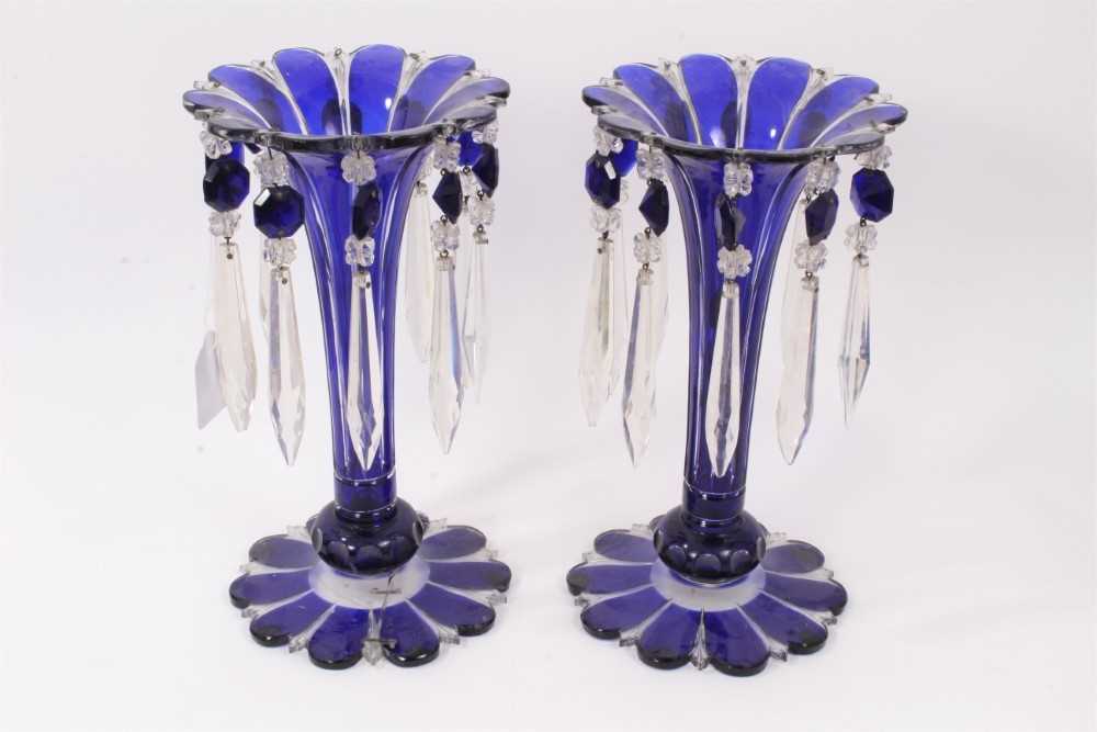 Lot 190 - Pair of Bohemian blue flash cut glass lustres with prismatic drops, 26.5cm high