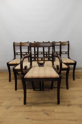 Lot 1324 - Set of six Regency style mahogany sabre leg dining chairs, each with slip on seat on reeded supports, with one elbow chair