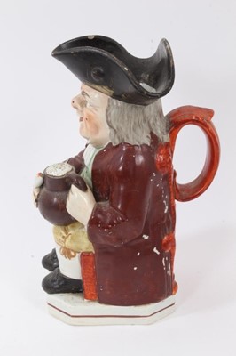 Lot 192 - Staffordshire pearlware-glazed Toby jug, circa 1820, typically modelled and polychrome painted, 25cm high