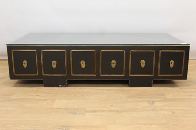 Lot 1357 - Chinese lacquered low cabinet, with gilt lining, with five drawers to each side on squat feet, 125cm wide cut 59cm deep x 33cm high