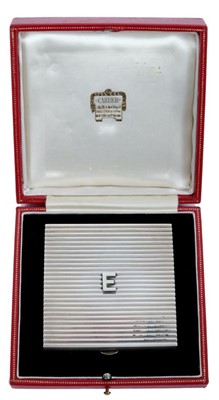Lot 61 - Lady Elizabeth Shakerley C.V.O. (1941-2020), Cartier silver powder compact of square ribbed form with central E monogram ( HM Birmingham 1972) 7cm x 7cm x 1cm, in original Cartier fitted red leath...