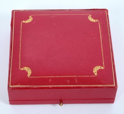 Lot 61 - Lady Elizabeth Shakerley C.V.O. (1941-2020), Cartier silver powder compact of square ribbed form with central E monogram ( HM Birmingham 1972) 7cm x 7cm x 1cm, in original Cartier fitted red leath...