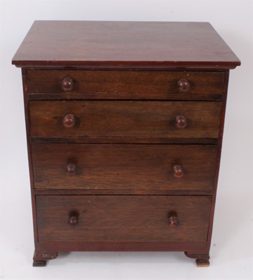 Lot 937 - Mahogany miniature chest of four graduated drawers with turned bun handles