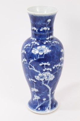 Lot 270 - Chinese blue and white porcelain vase, 19th century, of baluster form, decorated with prunus blossom, Kangxi mark to base, 26cm high