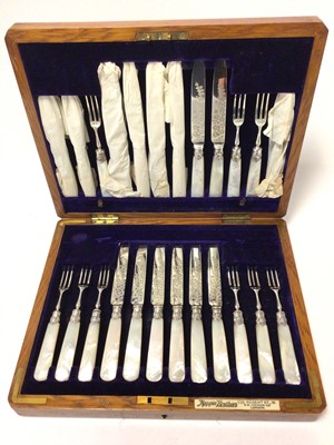 Lot 422 - Late Victorian canteen of silver fruit / dessert cutlery comprising twelve knives and twelve forks, with engraved foliate decoration and mother of pearl handles (Sheffield 1900)