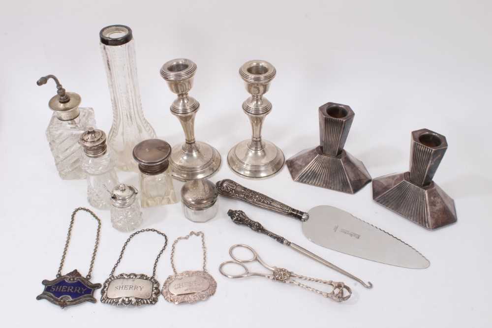 Lot 360 - Group silver mounted glass bottles, two silver Sherry labels and one other, pair silver candlesticks, plated pair, silver handled items and pair plated sugar tongs