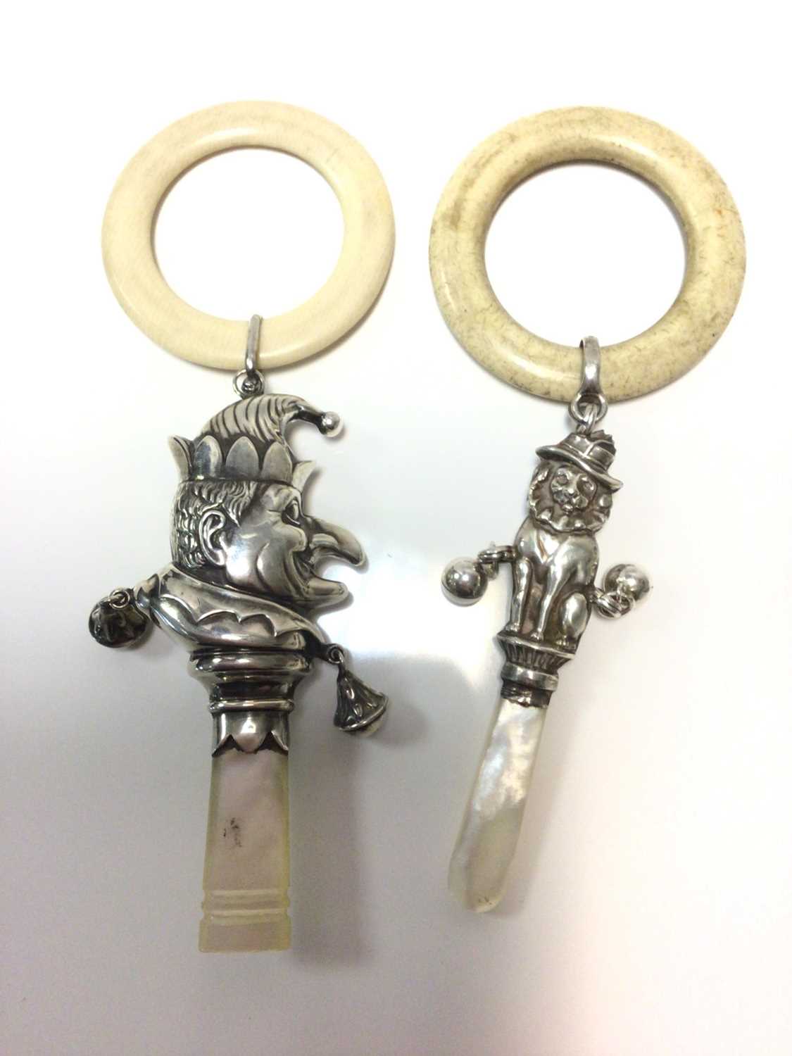 Lot 375 - Two 1930s silver child's rattles in the form of Mr Punch and Toby